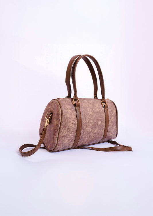 Brown suede handbag with strap on light background